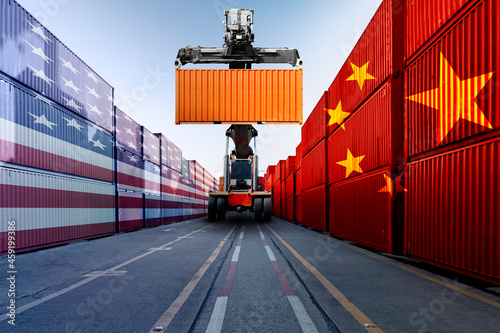 Metaphor image of United States of America and China trade war tariffs as two opposing container cargo and forklift in the port as an economic taxation dispute over import and exports concept