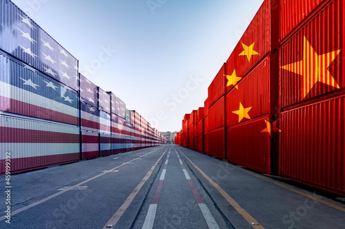 Metaphor image of United States of America and China trade war tariffs as two opposing container cargo in the port as an economic taxation dispute over import and exports concept photo