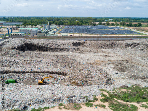 Huge garbage pile landfill and waste disposal plant and biogas plant with gas digester , plastic pollution crisis. global warming, Ecosystem and healthy environment concepts