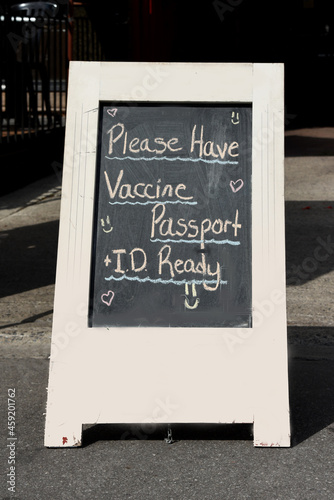Sign at entrance of restaurant in Ontario, Canada stating proof of full vaccination plus ID is necessary to dine inside.