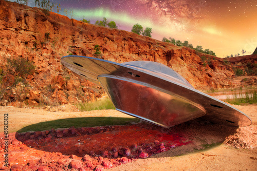 Unidentified Flying Object crashed in the wasteland desert at night, science fiction scene with alien spaceship and mysterious lights