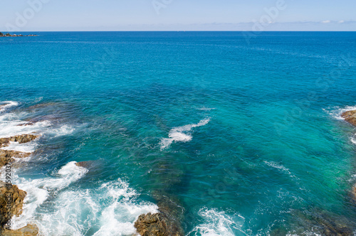 Aerial view Top down seashore wave crashing on seashore Beautiful turquoise sea surface in sunny day Good weather day summer background Amazing seascape