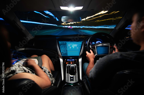 Futuristic interface of autonomous car. self driving vehicle. connected the internet of things. heads up display of a car driving at night through an illuminated on road