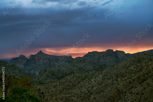Dramatic sunset sky with monsoon rain over Thimble Peak in Tucson
