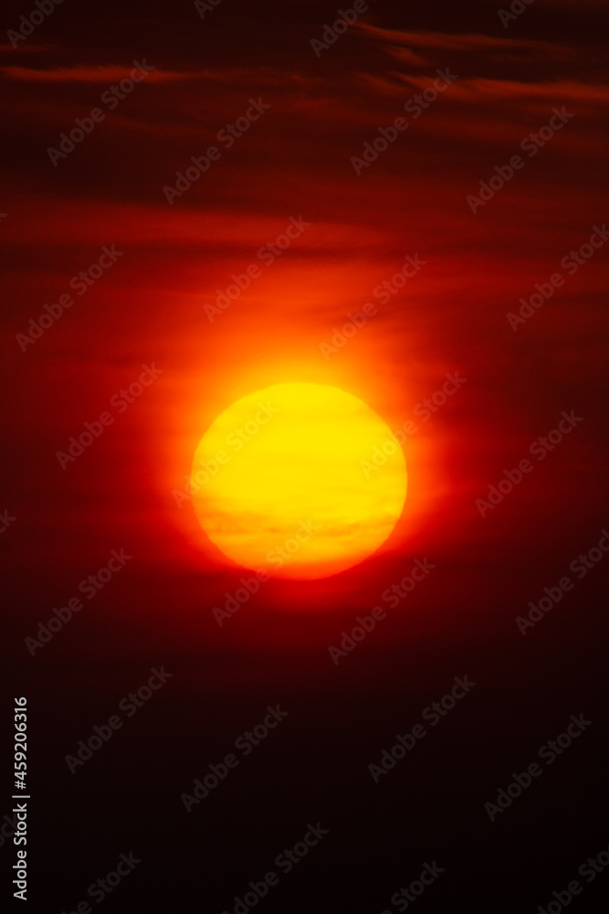 Bright warm sun on sky background. Dawn or sunset. Bright warm sun on sky background. Dawn or sunset.