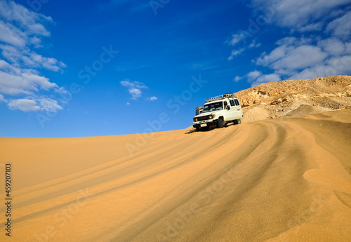 Off-road vehicles driving in the Sahara sand desert 