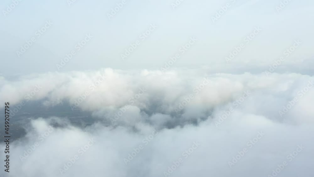 View from above, drone point of view, stunning aerial video of a drone flying over some fluffy moving clouds. Copy space, natural background, video transition. View from above, drone point of view, stunning aerial video of a drone flying over some fluffy moving clouds. Copy space, natural background, video transition.