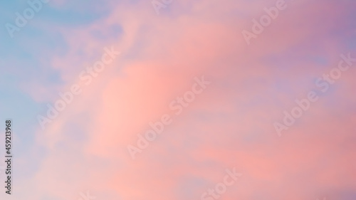 Background of blue sky with pale pink clouds in sunset © OLAYOLA