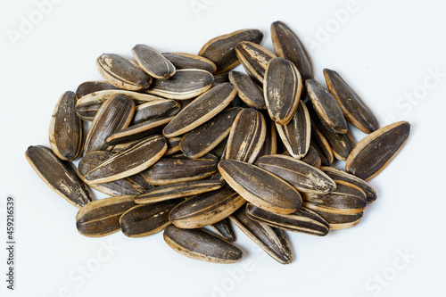 A pile of unpeeled sunflower seeds isolated on white background. Close-up of sunflower seeds isolated.