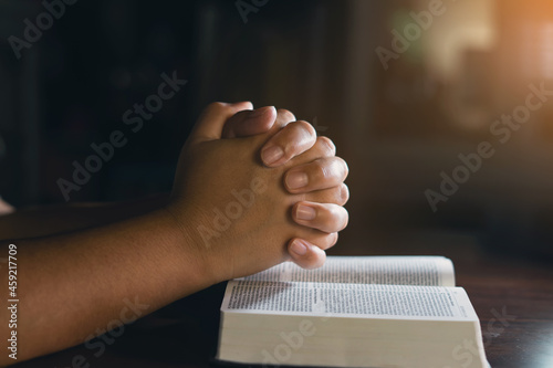 Christian hands while praying and worship for Jesus. We love god. christian people praying while hands worship over a Bible. christian background. freedom. learning religion.