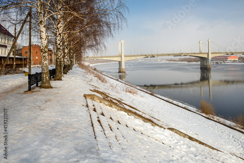 Savelovsky bridge over Volga River in Kimry town, Tver oblast, Russia. View from the Fadeev embankment on a winter day. Architecture, buildings and scenic nature. Landscape of Kimry © Konstantin