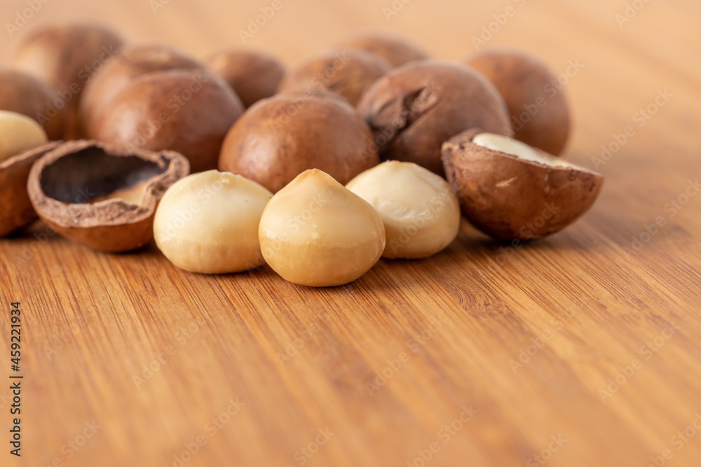 Macadamia nuts on wooden table Macadamia nuts on wooden table