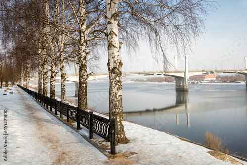 Savelovsky bridge over Volga River in Kimry town, Tver oblast, Russia. View from the Fadeev embankment on a winter day. Architecture, buildings and scenic nature. Landscape of Kimry
