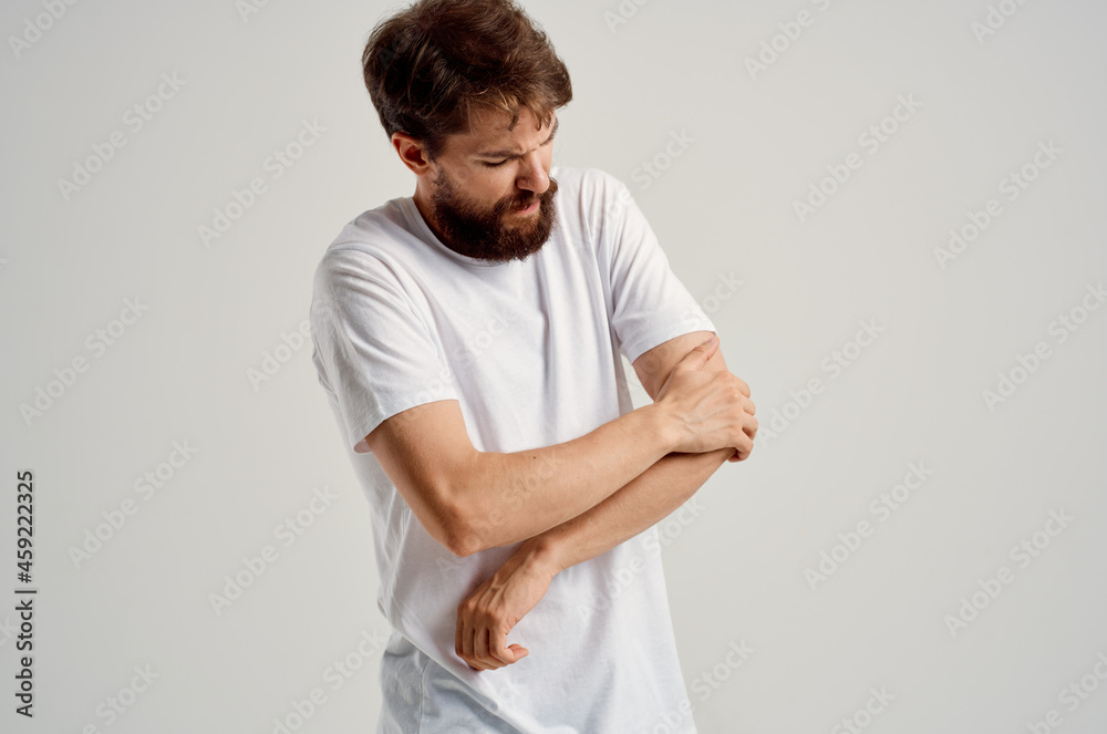 man in white t-shirt hand injury health problems joint pain man in white t-shirt hand injury health problems joint pain