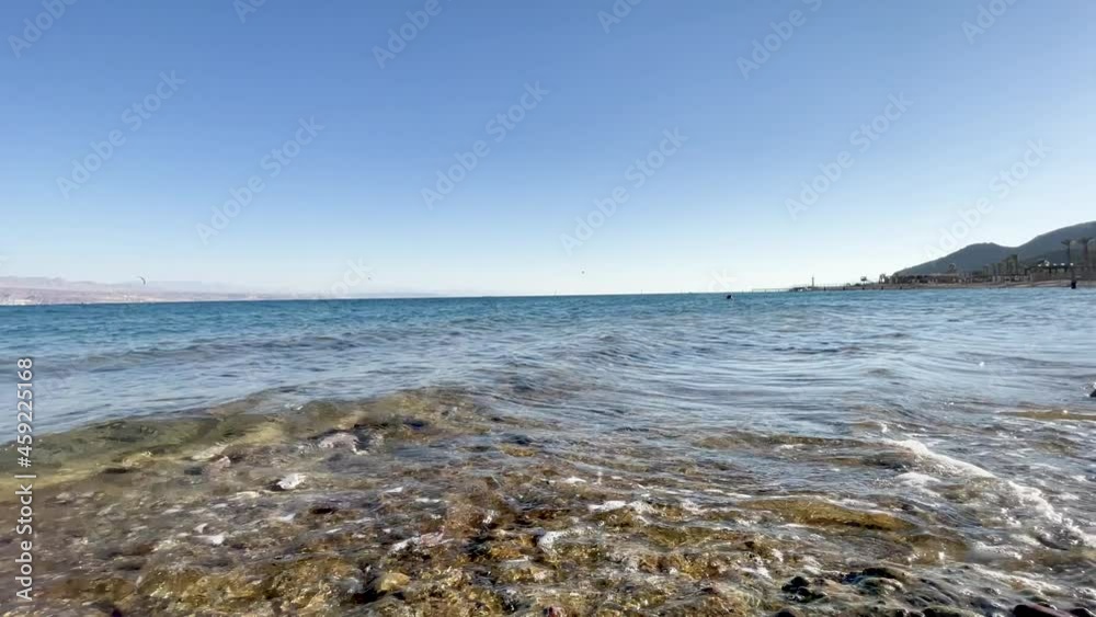 Small waves on the Red Sea beach at sunset in the resort of Eilat in Israel Small waves on the Red Sea beach at sunset in the resort of Eilat in Israel