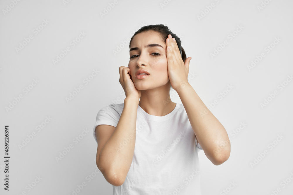 woman in white t-shirt headache health problems woman in white t-shirt headache health problems