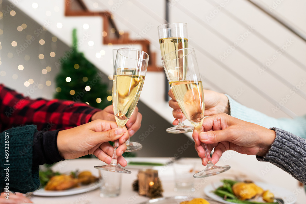 Close up of Christmas toasting with champagne. Happy family celebrating Christmas together. Close up of Christmas toasting with champagne. Happy family celebrating Christmas together.