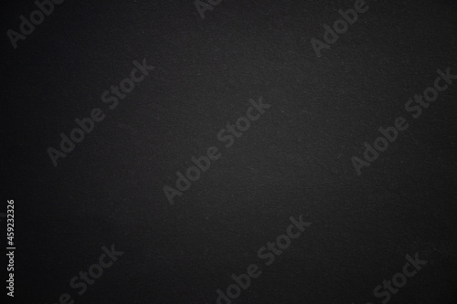 Black cardboard sheet. Dark background for the text. Black texture for the banner.