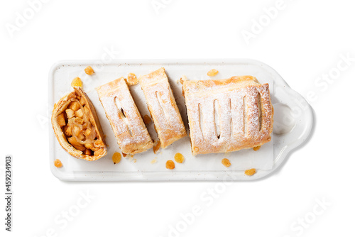 Traditional homemade apple strudel with caramelized apples and raisins. isolated on white background. top view photo