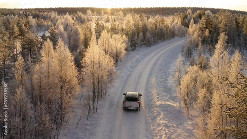 car driving on rural offroad in wild winter forest destination explore environment on trip, aerial view of wood on north and auto with equipment for extreme path and locations
