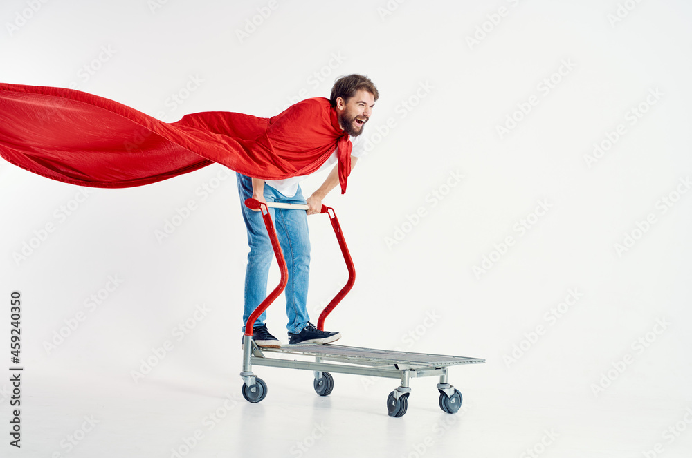 Fototapeta premium Cheerful man ride a cart entertainment light background