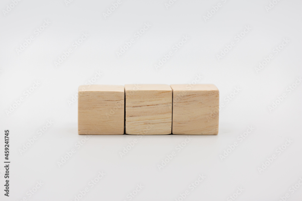 Three blank wooden block cubes on a white background for your text. Three blank wooden block cubes on a white background for your text.