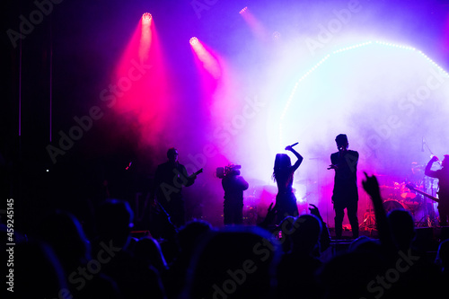 crowd at concert and silhouettes in stage lights