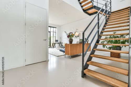 Designed in a minimalistic style staircase hall. Interior of luxury house stairs photo