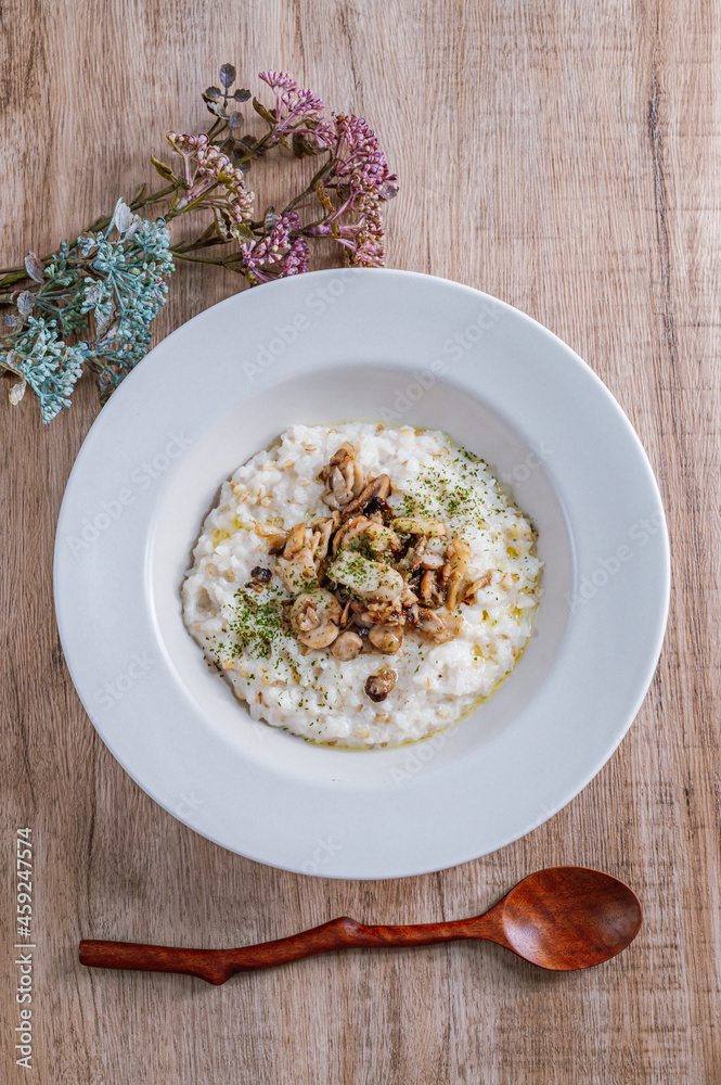 Mushroom risotto in a white bowl Mushroom risotto in a white bowl
