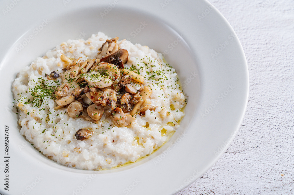 Mushroom risotto in a white bowl Mushroom risotto in a white bowl