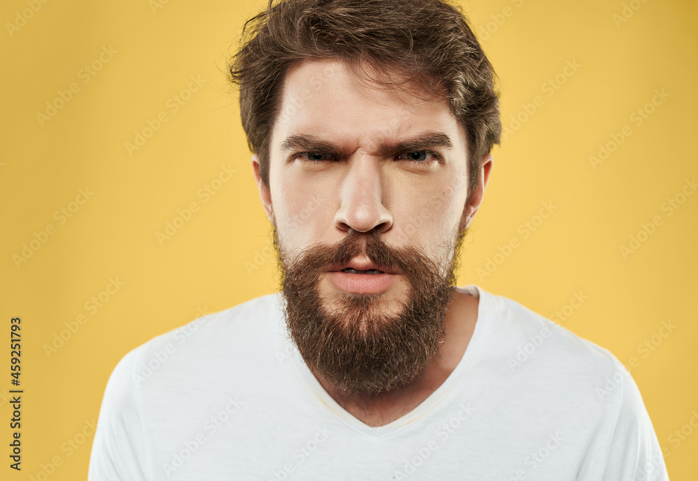 Man in a white t-shirt expressive look discontent close-up Man in a white t-shirt expressive look discontent close-up