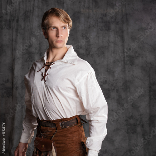 A young man in a leather kilt and a white lace-up blouse. A Scottish knight