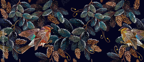 Winter art. Classical embroidery snow-covered branch of a fir-tree, bullfunch and titmouse birds. Christmas art pattern. Clothes, textile design template