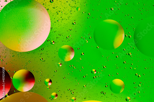 Abstract colorful background of oil circles. Oil in the water surface circles, water foam and oil bubbles.
