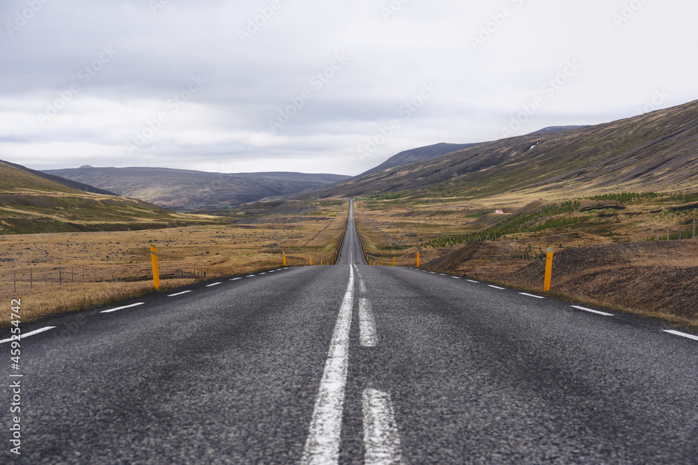 Panoramic view of an empty Icelandic road during a cloudy summer day Panoramic view of an empty Icelandic road during a cloudy summer day
