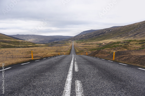 Panoramic view of an empty Icelandic road during a cloudy summer day