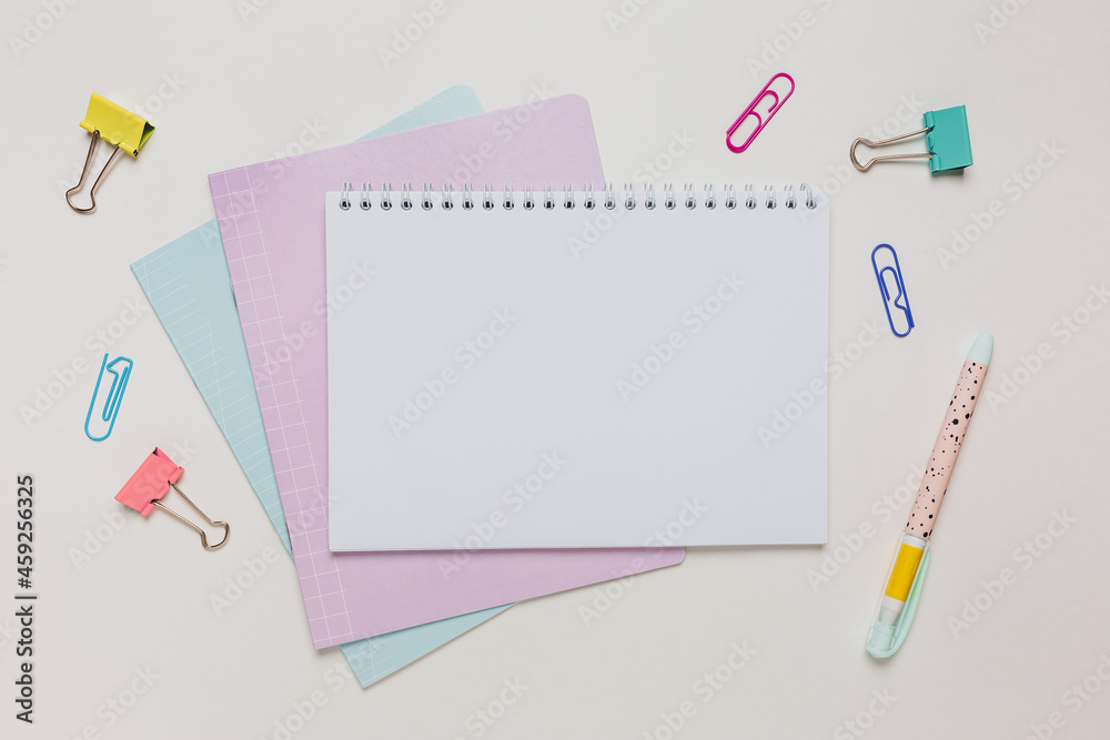 Notepad, exercise book and pen on the desk. Mock up in copy space office on white background. Back to school Notepad, exercise book and pen on the desk. Mock up in copy space office on white background. Back to school