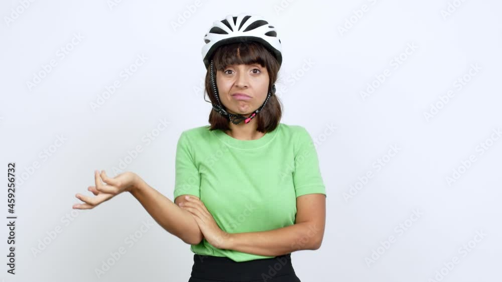 Young woman with bike helmet over isolated background having doubts over isolated background Young woman with bike helmet over isolated background having doubts over isolated background