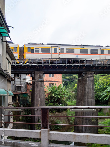 Train of Pingxi Railway Line traveling in Pinghsi old street, New Taipei City, Taiwan