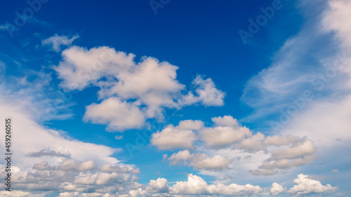 Fototapeta Naklejka Na Ścianę i Meble -  Blue sky fluffy white clouds on summer season bright clear skyline with beautiful cloudscape. Panorama blue sky clouds pattern on daylight with copy space. Cumulus cloudscape air climate sunny day