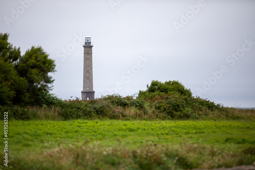 Lighthouse with clouds and garden