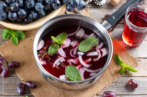 Frozen wine sauce in a stewpan on a wooden table.