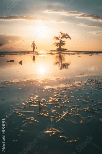 People walking on the beach at sunset for holiday time