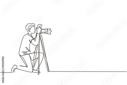 Single continuous line drawing professional photographer man kneeling for taking pictures with digital camera and tripod. Digital photography hobby. One line draw graphic design vector illustration photo