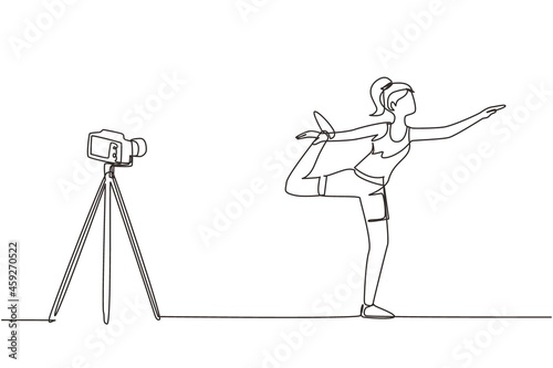 Continuous one line drawing woman blogger in sportswear shoots video on camera doing exercises at home. Fitness vlogger live broadcast of training session. Single line draw design vector illustration