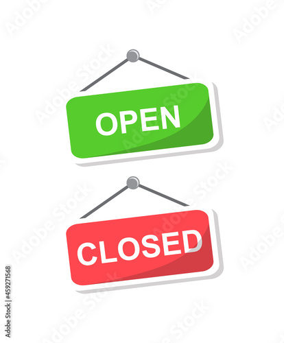 two bright plaques hang on a nail. on the red plate it says CLOSED.
the green nameplate reads OPEN 