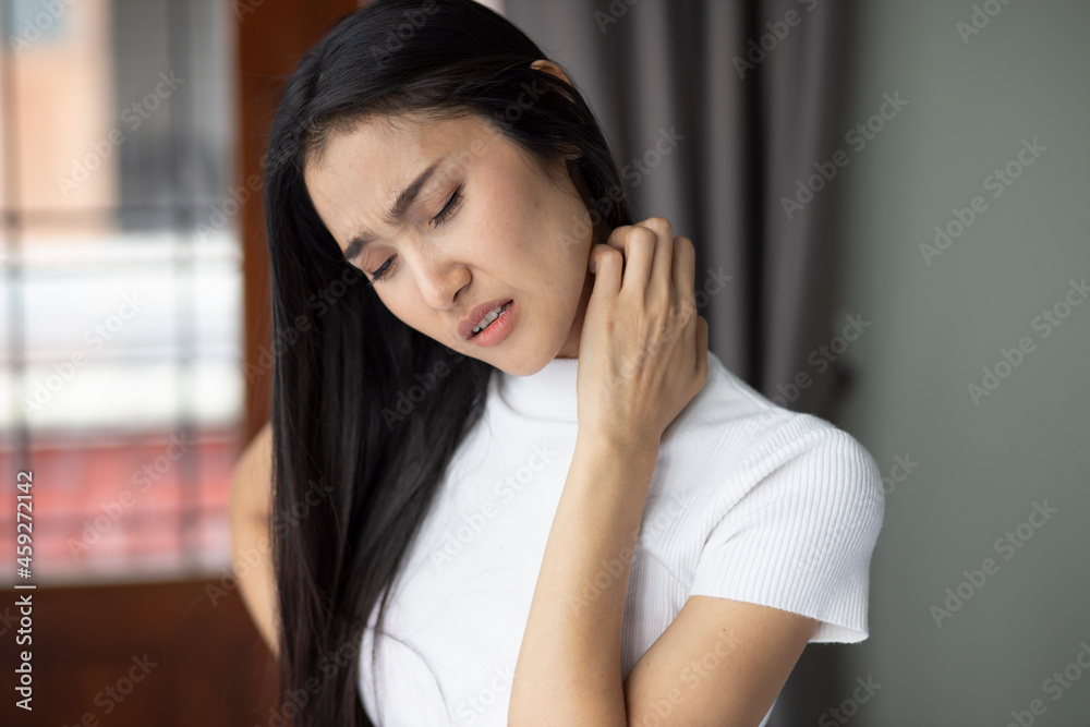 Asian woman scratching her neck skin, concept of dry skin, allergic dermis inflammation, fungus infection, dermatology disease, eczema, rash, skin care Asian woman scratching her neck skin, concept of dry skin, allergic dermis inflammation, fungus infection, dermatology disease, eczema, rash, skin care
