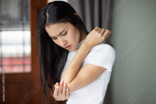 Photography Asian woman suffering from tennis elbow syndrome, pain from elbow injury