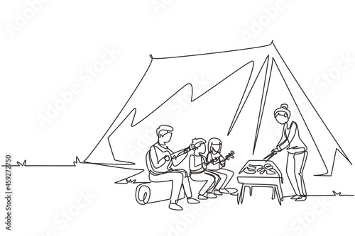 Single continuous line drawing happy family member are having barbecue in campsite. Father playing guitar, mother and kids preparing food for dinner at nature. One line draw design vector illustration