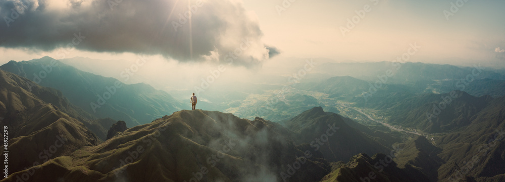 Man standing on mountain top - obrazy, fototapety, plakaty 